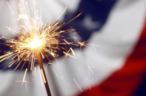 a firework on top of a faded out american flag background