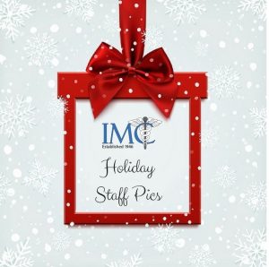 Image shows snow and a box shaped like a present with text. Text Says - "IMC Holiday Staff Pics" -