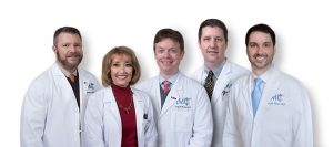 Picture of 5 doctors (4 men 1 woman) in white lab coats.