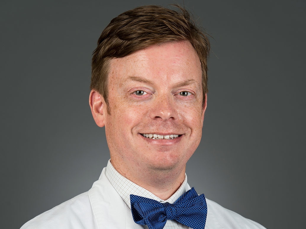 Picture of Cody B. Barnett, M.D., FACG in a white lab coat and blue bow tie
