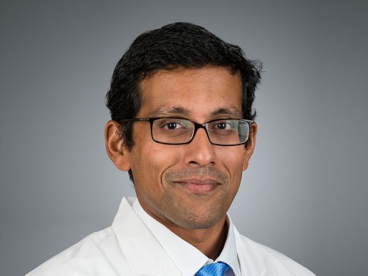 Picture of Deepak Kumar, M.D. in white lab coat and blue tie