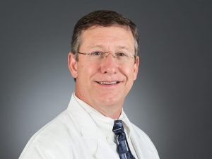 Picture of Donald B. Sanders, M.D. in white lab coat and dark tie