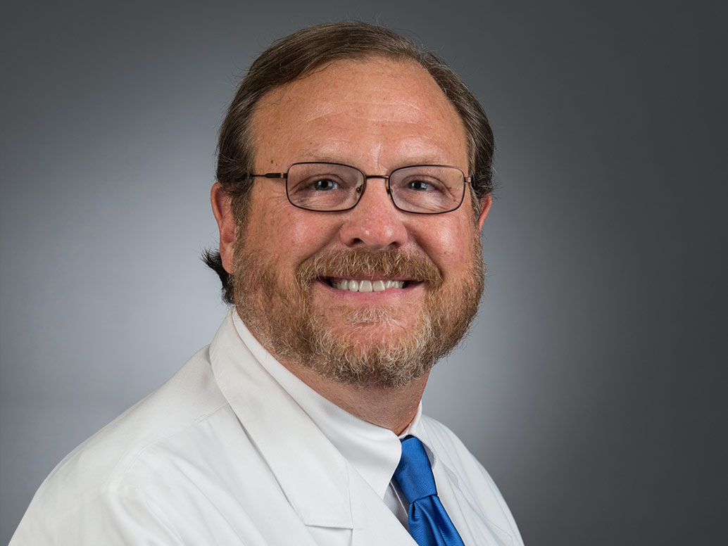 Picture of Mark C. Wiles, M.D. in white lab coat and blue tie