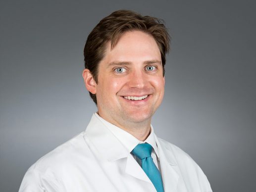 Picture of Patrick L. Murphy Jr., M.D. in white lab coat and light blue tie