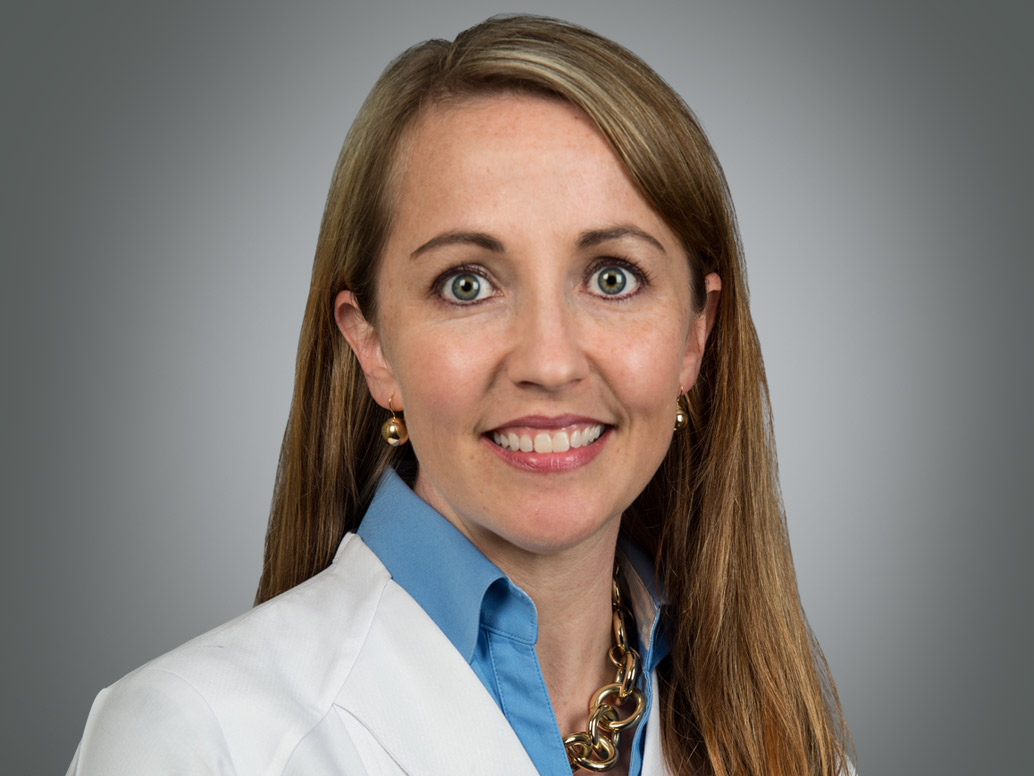Pictor of Clare K. Carney, M.D., Ph.D. in a white lab coat