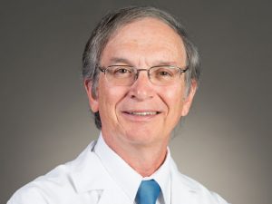 Picture of Stephen G. Alsip, MD in a white lab jacket and blue tie