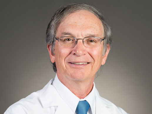 Picture of Stephen G. Alsip, MD in a white lab jacket and blue tie