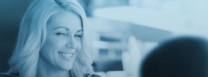 Women with blonde hair smiling with blue overlay