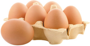 5 eggs in a small open carton of eggs. One egg is sitting in front of the carton