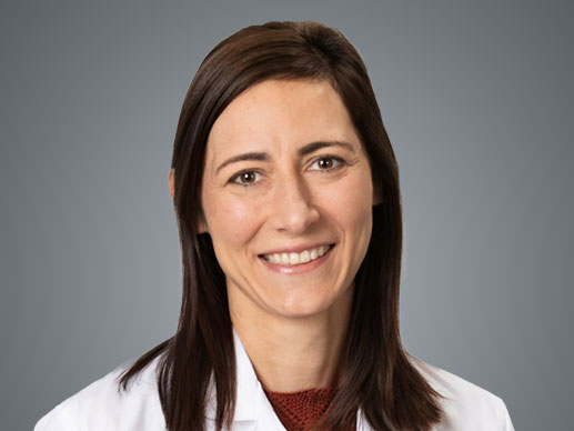 Picture of Melissa Reimer-McAtee, MD in a white lab jacket and maroon top